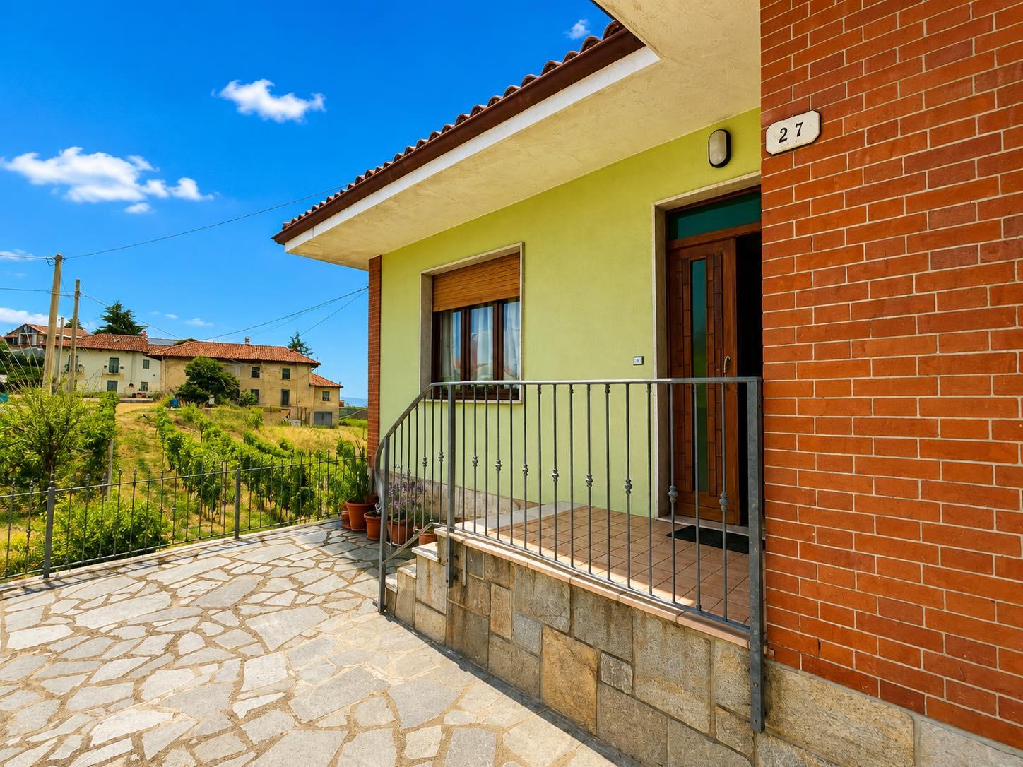 Entrance and stone-paved terrace of the farmhouse