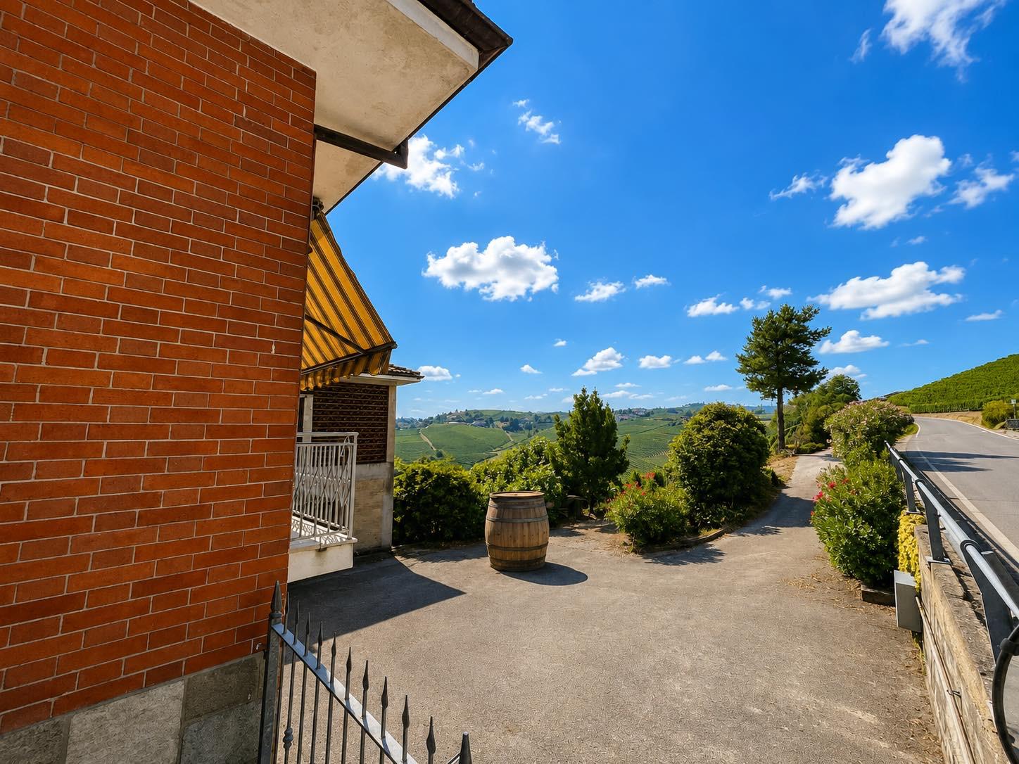 Side of the farmhouse with panoramic vineyard views