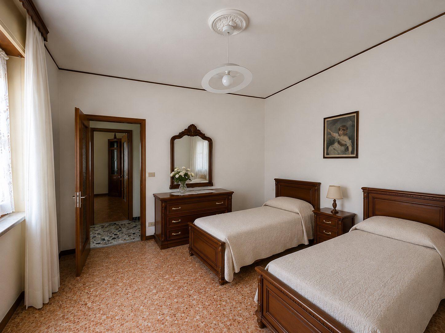 Twin bedroom with antique wooden furniture