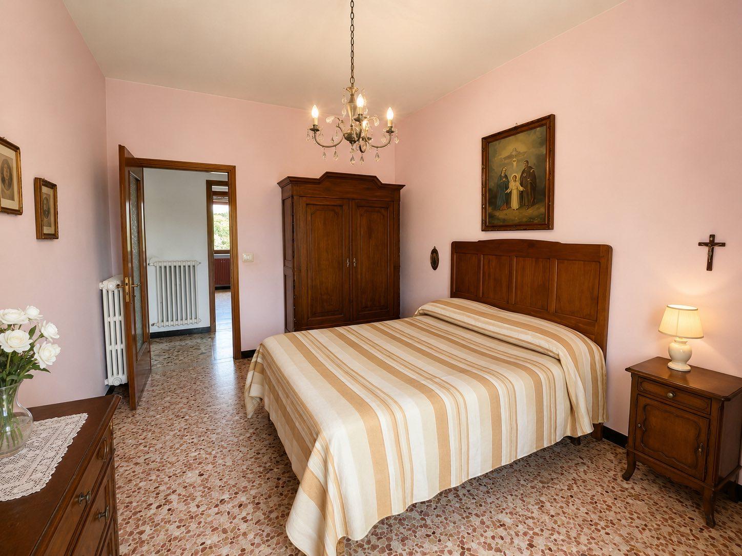 Bedroom with chandelier and wooden wardrobe